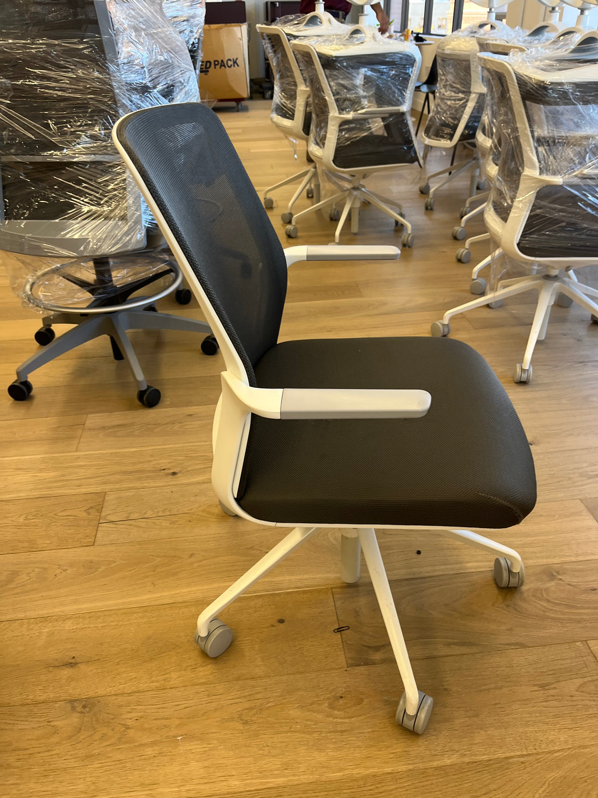 White mesh conference chairs with fixed arms