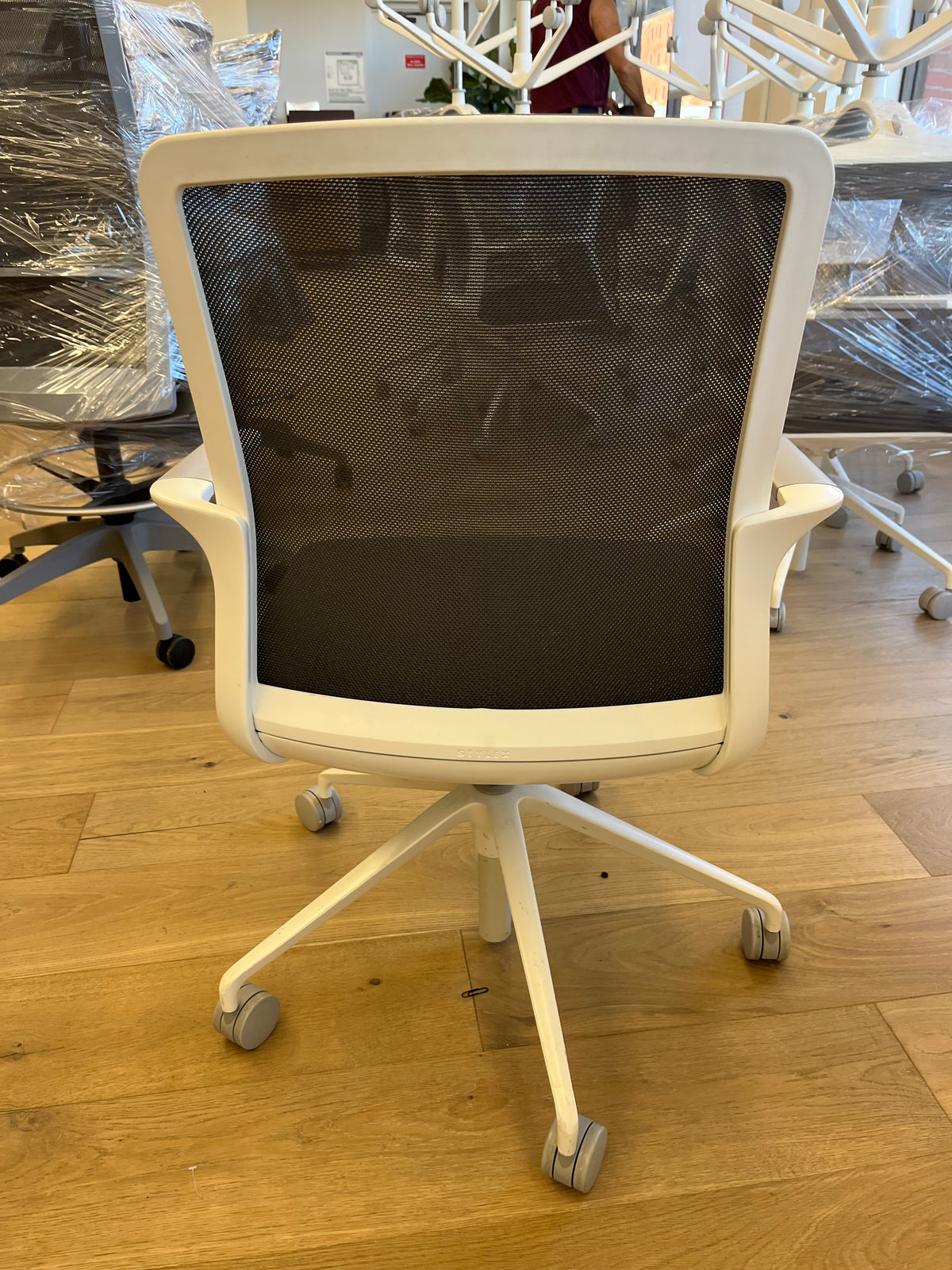 White mesh conference chairs with fixed arms
