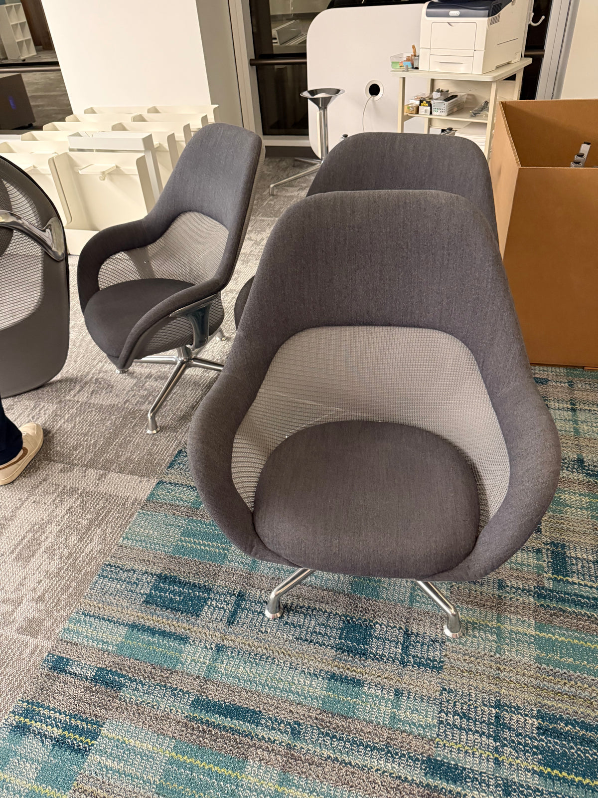 Gray lounge area chairs with polished base