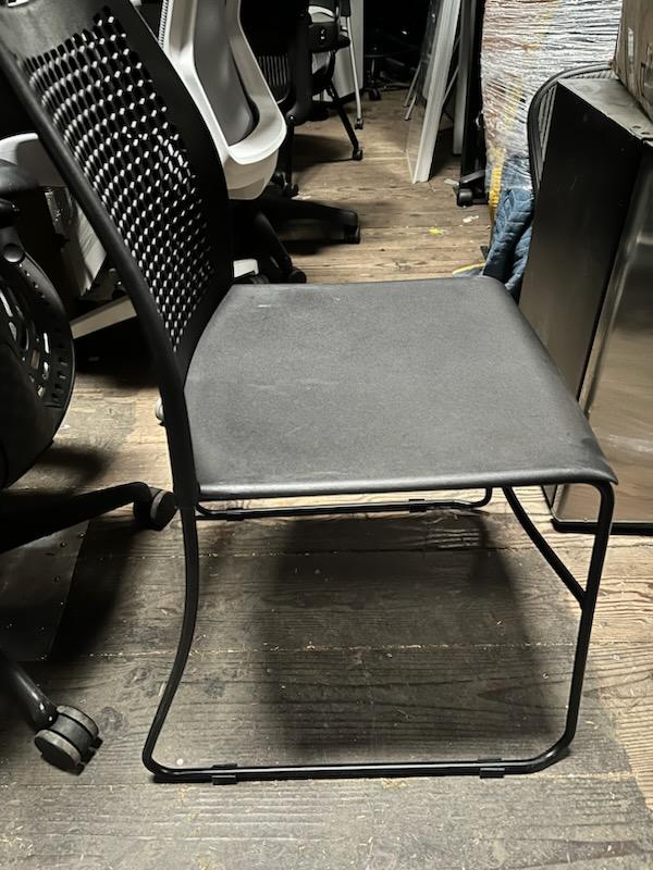 Black stacking chairs with Breathable holes in back