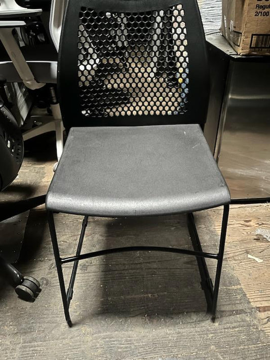 Black stacking chairs with Breathable holes in back