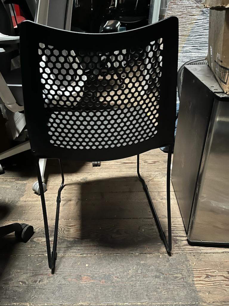 Black stacking chairs with Breathable holes in back